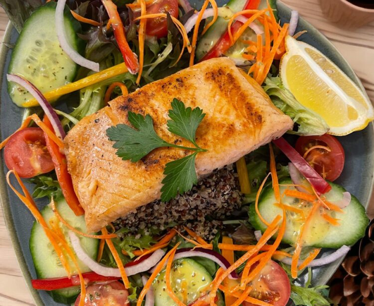 Pescatarian? Try the delicious grilled salmon on a salad of quinoa, pistachio and dates, at Old Bar Village Cafe.