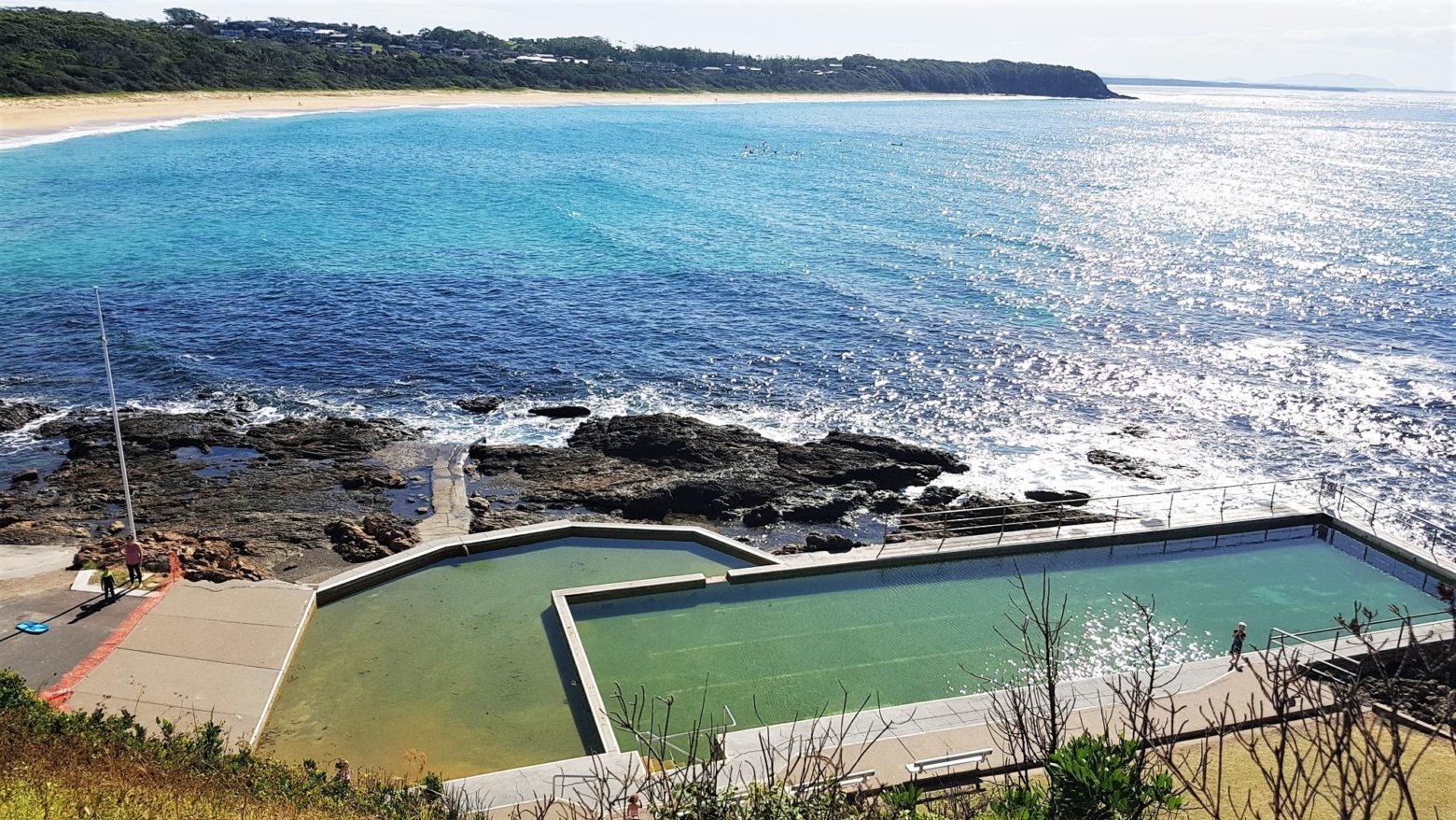 Black Head ocean baths with Black Head beach in background.